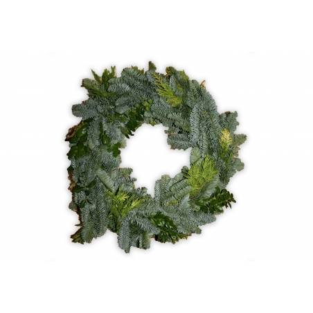 A lush green wreath made of pine and assorted foliage, inviting a fresh, natural vibe. A lush green wreath made of pine and assorted foliage, inviting a fresh, natural vibe.