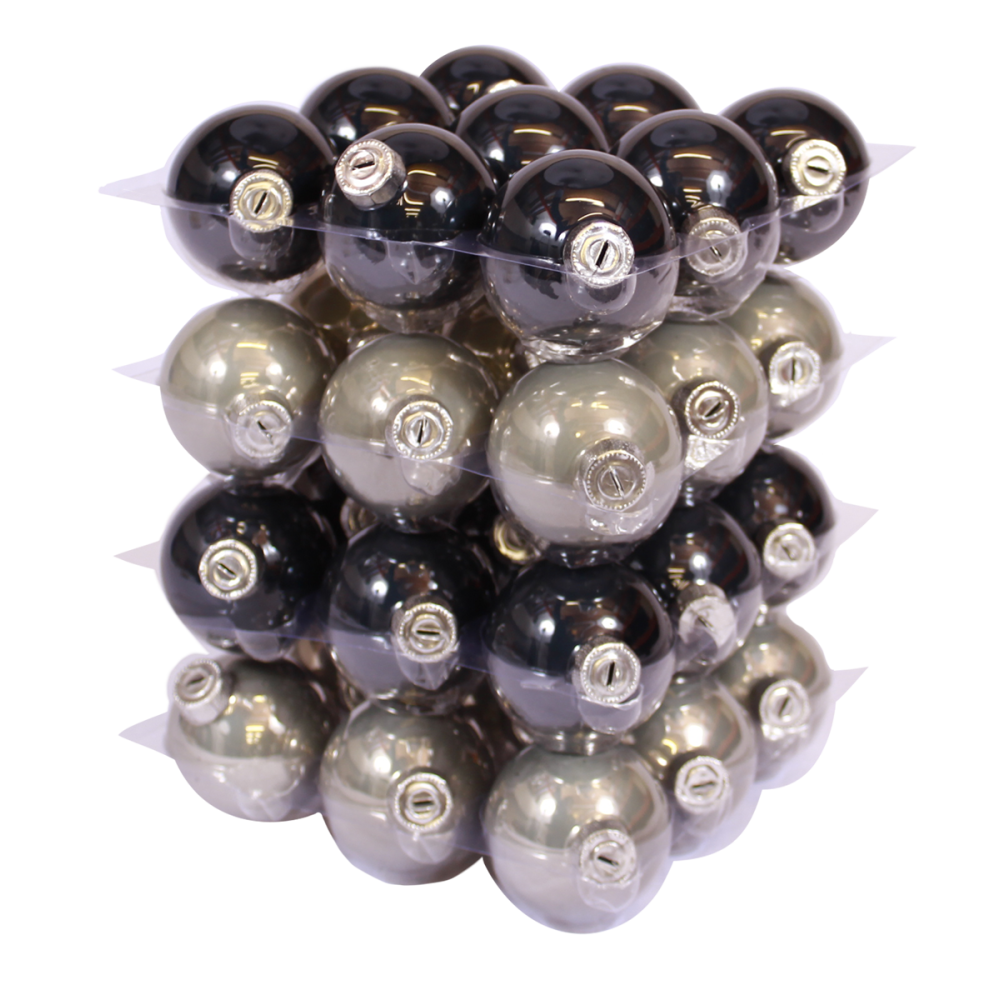 A stack of shiny holiday ornaments in black, silver, and gray hues, arranged in layers.
