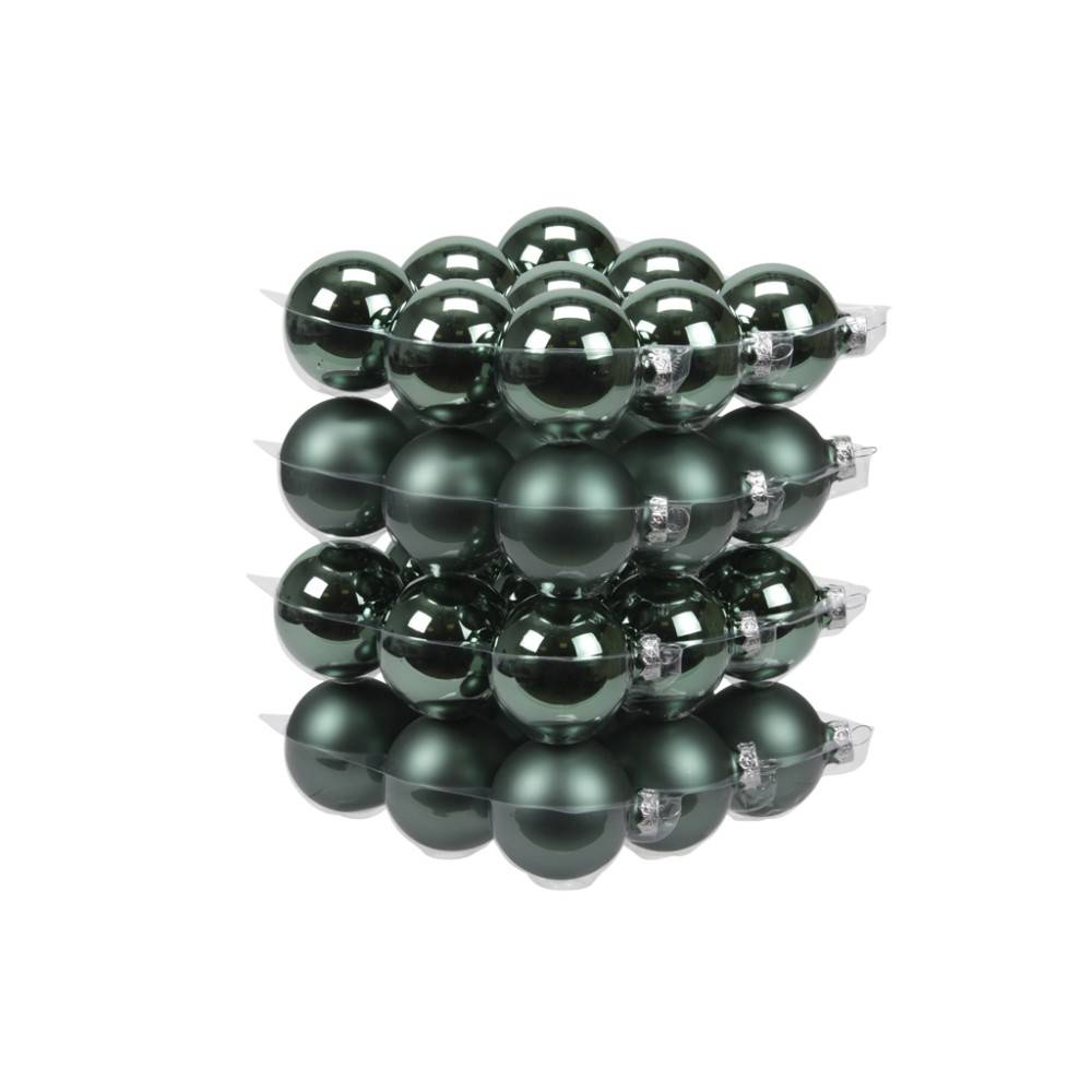 A stack of dark green, glossy Christmas ornaments, round and reflective, arranged neatly.