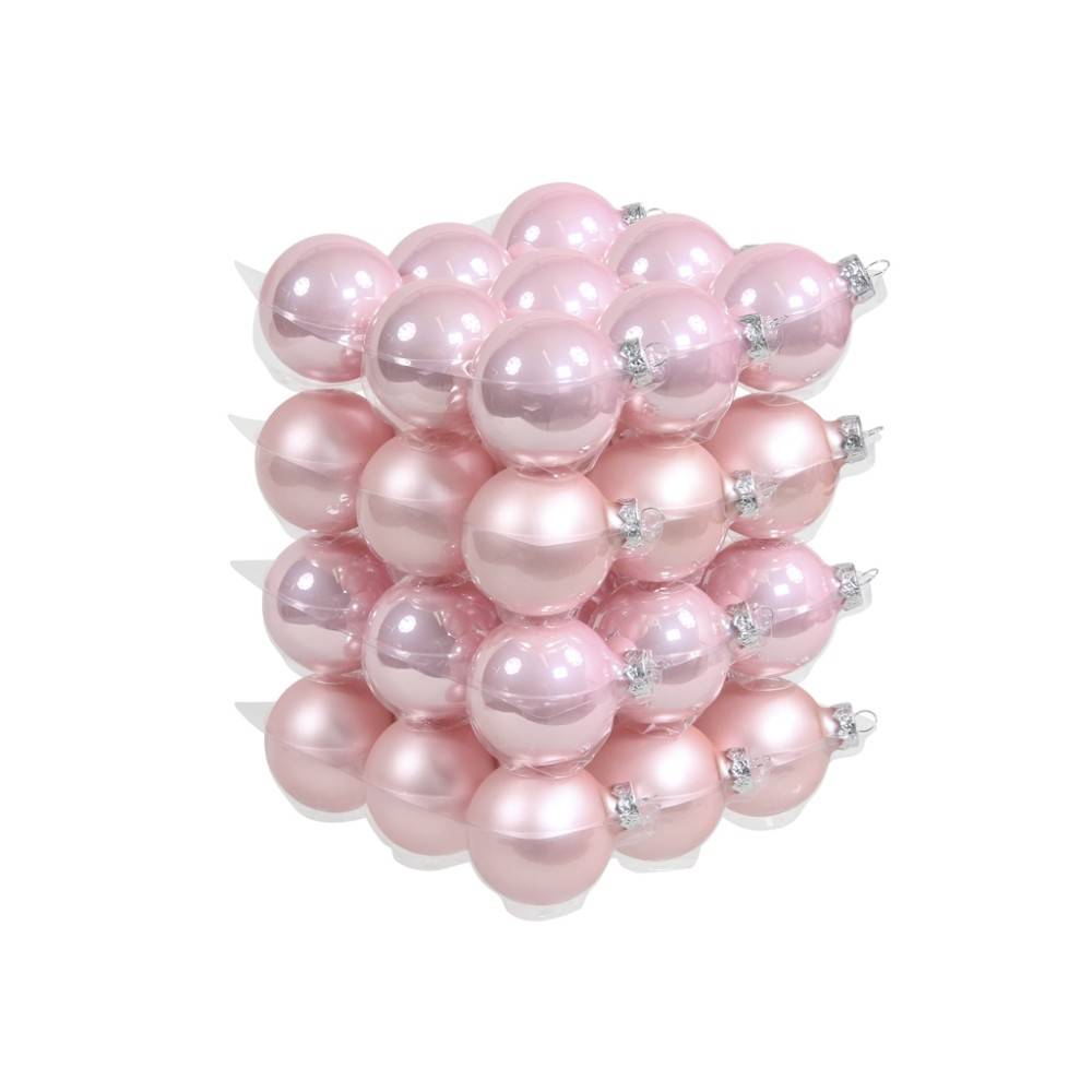 A stack of shiny pink Christmas ornaments, varying in shades and finishes, creating a festive look.