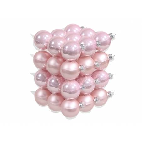 A stack of shiny pink Christmas ornaments, varying in shades and finishes, creating a festive look.