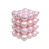 A stack of shiny pink Christmas ornaments, varying in shades and finishes, creating a festive look.