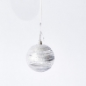 A shimmering silver ornament with textured stripes hanging against a plain white background.