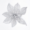 A shimmering silver flower with intricate, lace-like petals and a sparkling center.
