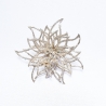 A delicate, shimmering silver flower brooch with intricate petal designs.