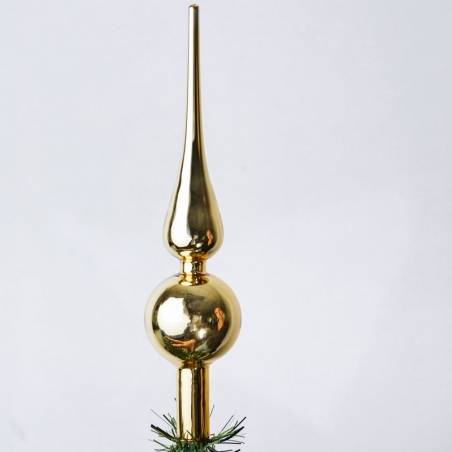 A shiny, gold tree topper with a pointed tip and a round base, reflecting light beautifully.