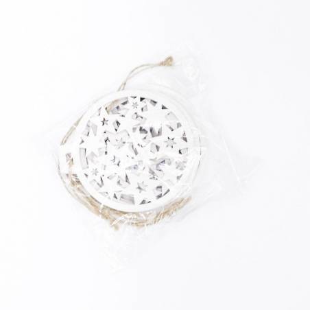 A circular white decoration with intricate star cutouts, packaged with twine.