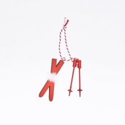 Red wooden ski ornament with white fur detail, hanging on a striped string.
