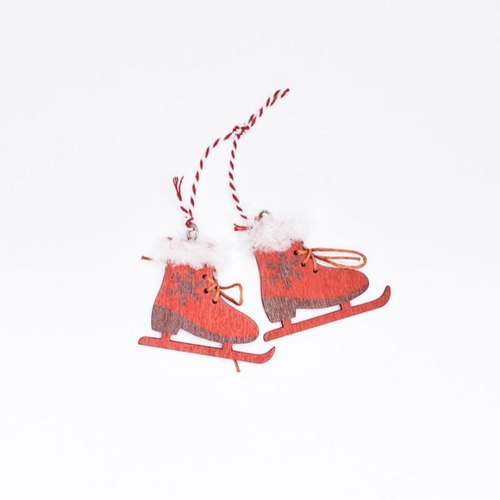 Red decorative ice skates with white fur trim and twine for hanging.