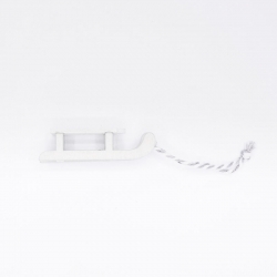 A simple white wooden sled with a twisted string for pulling.