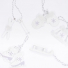 Winter-themed ornaments featuring ice skates, mittens, and snowflakes in soft white and purple.