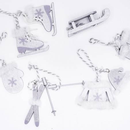 Wooden holiday ornaments in winter shapes, featuring skates, mittens, and a sled with white accents.