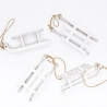 Four small white wooden sleds with twine for hanging, arranged playfully on a white background.