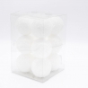 A clear box containing several white, fluffy spherical decorations.