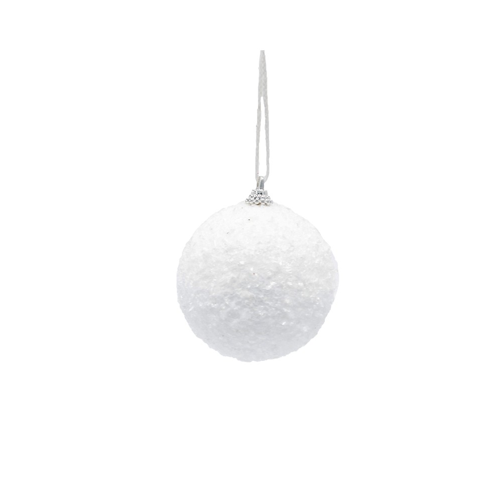 A textured, white Christmas ornament hangs against a bright background, radiating simplicity.