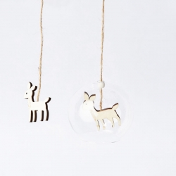 Two wooden deer ornaments, one inside a clear glass sphere, hanging on twine against a white back...