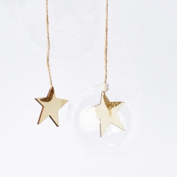 Two gold stars hang from twine, one above a clear, round ornament against a white background.