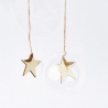 Two gold stars hang from twine, one above a clear, round ornament against a white background.