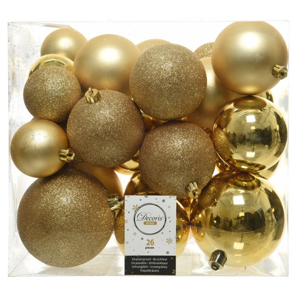 A collection of shiny gold and glittering ornaments in various sizes, packed in a clear box.