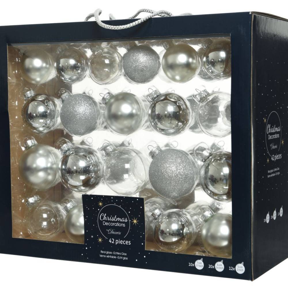 A box filled with silver and glittery Christmas ornaments in various shapes and sizes.
