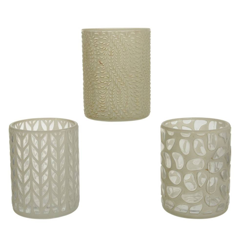 Three decorative glass candle holders with intricate cut-out patterns and a soft, neutral color.