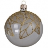 A round glass ornament in white with delicate gold leaf patterns.