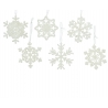 Delicate white snowflake ornaments, each with unique intricate patterns, hang on thin threads.