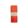 A vibrant orange scarf, elegantly folded with a simple white label.