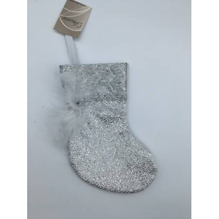A shimmering silver stocking adorned with glitter and a delicate white feather.