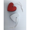 Two heart-shaped tags, one red and one white, with thin strings for hanging.
