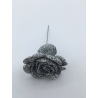A sparkling silver rose made of glitter, resting on a thin metallic stem. A sparkling silver rose made of glitter, resting on a thin metallic stem.