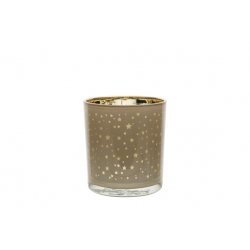 Glazen kaarsenhouder met gouden sterren op een zachte bruine achtergrond en een gouden rand.