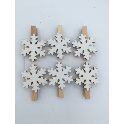 Wooden clothespins adorned with white, snowflake-shaped decorations.