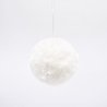 A soft, round, white fluffy object suspended against a plain background.