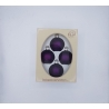 Four purple ornaments in a cream-colored box with an oval window.