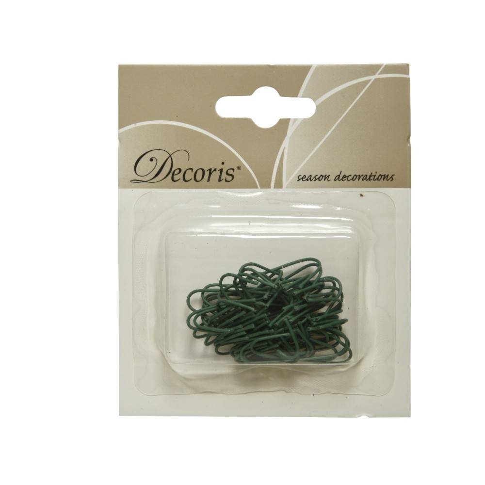 A pack of green decorative wires in a clear plastic container on a light beige background.