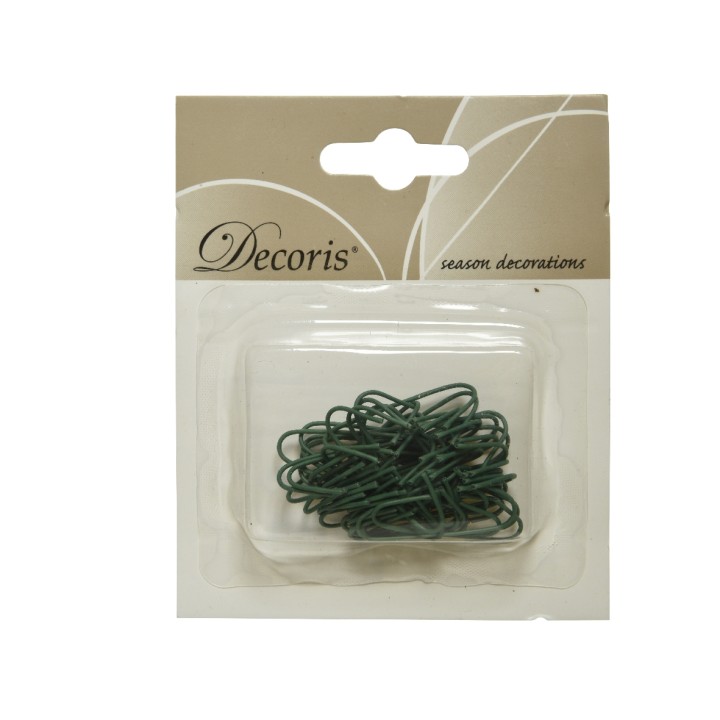 Groene decoratieve draadjes in een doorzichtige verpakking met een beige achtergrond.