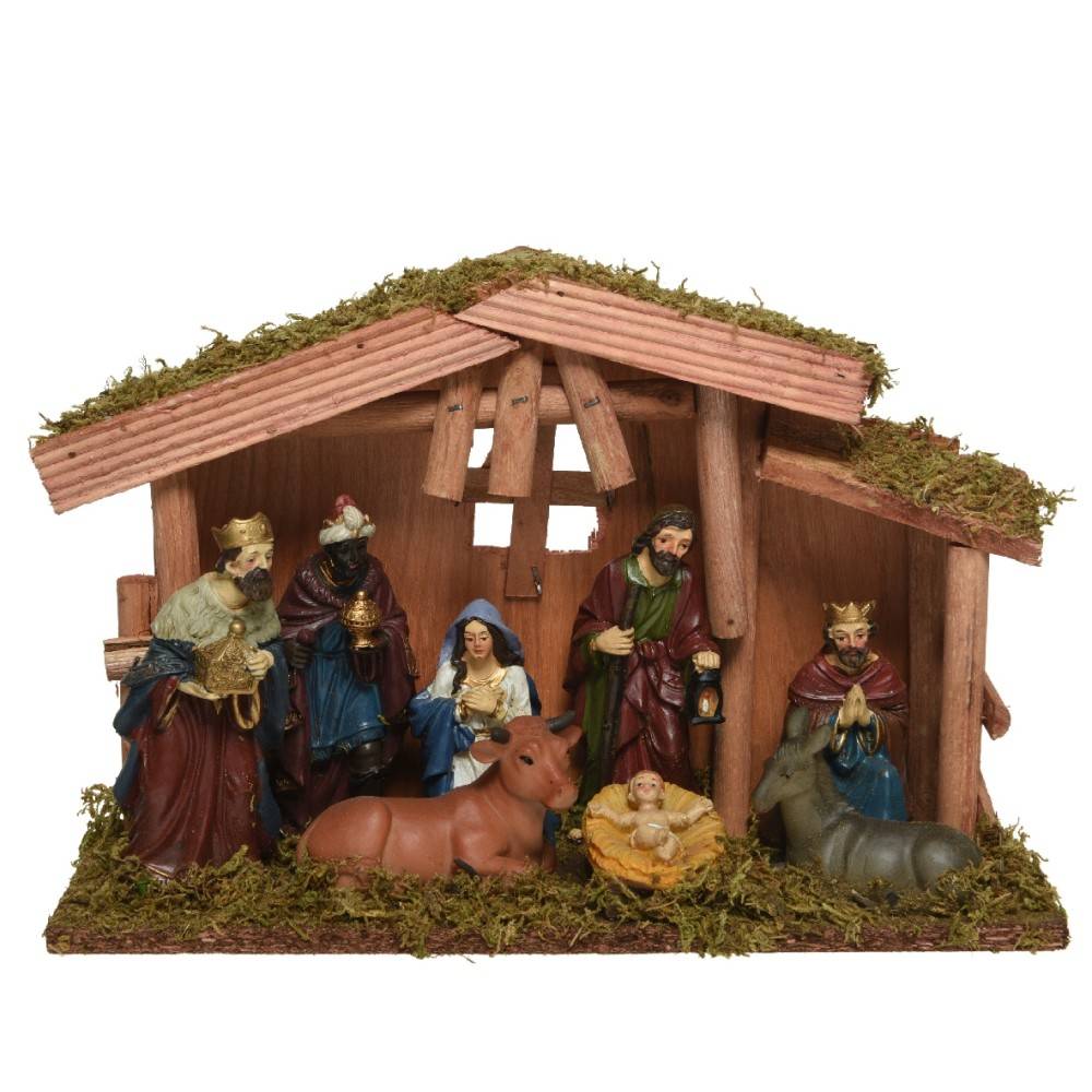 A rustic nativity scene with figures of Mary, Joseph, and three kings, surrounded by moss.