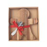 A wooden gingerbread man with a silver spoon, tied with a red ribbon in a box.