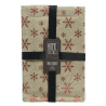 A beige table runner adorned with red snowflakes, neatly packaged with a black ribbon.