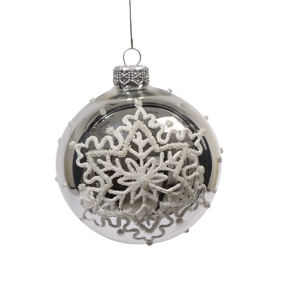 A clear glass ornament adorned with a delicate white snowflake design and silver accents.