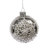 A clear glass ornament adorned with a delicate white snowflake design and silver accents.