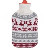 A cozy hot water bottle with a festive knit cover featuring red reindeer and snowflakes.