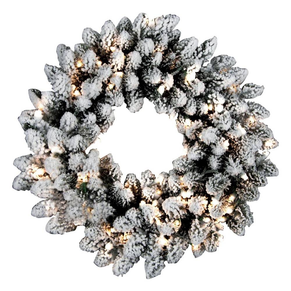 A snowy pinecone wreath adorned with warm white lights, creating a festive ambiance.