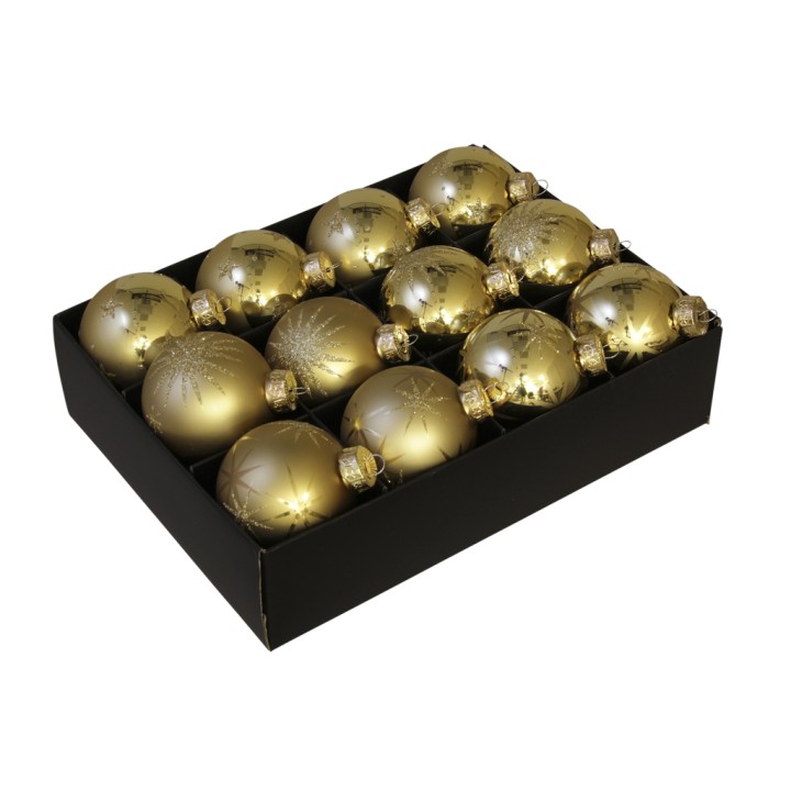 Gouden kerstballen in een zwarte doos, met glanzende en matte afwerkingen.