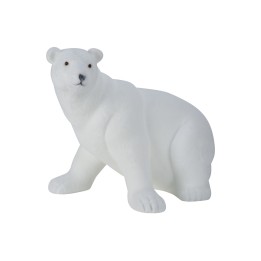 A smooth, white sculpture of a polar bear in a sitting position, with subtle detailing.