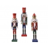 Three colorful wooden nutcracker figures, each with distinct outfits and playful expressions.