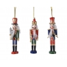 Three colorful nutcracker ornaments with detailed outfits and cheerful expressions.