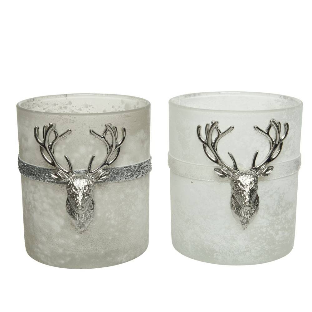 Two frosted candle holders, one gray and one white, adorned with silver deer head accents.