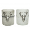 Two frosted candle holders, one gray and one white, adorned with silver deer head accents.